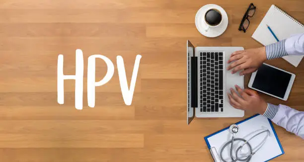 Photo of HPV CONCEPT Virus vaccine with syringe HPV criteria for pap smear slide cytology.