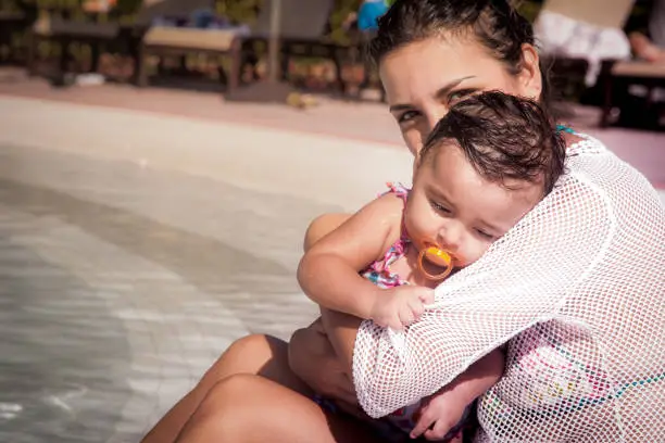 Mom and little baby girl at pool