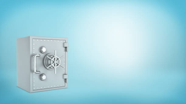 istock A closed metallic old-fashioned safe-box with a wheel on blue background 682068068