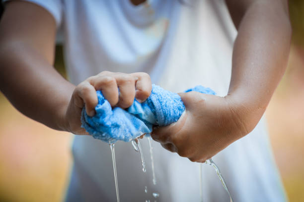 child-hands-squeeze-wet-blue-towel-and-water-drop.jpg