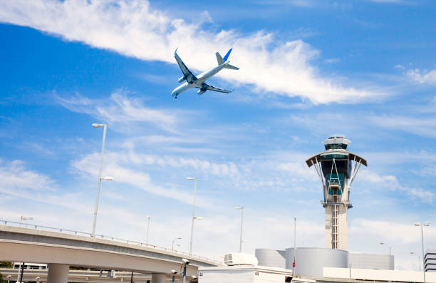 istock Airplane flying and air traffic control tower 682077808