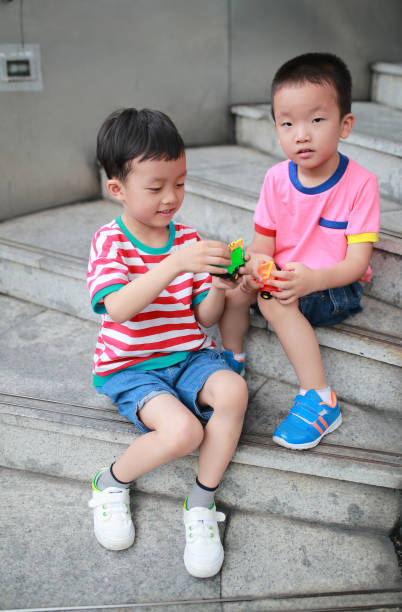 istock Cute Asian children and toy car 682080848