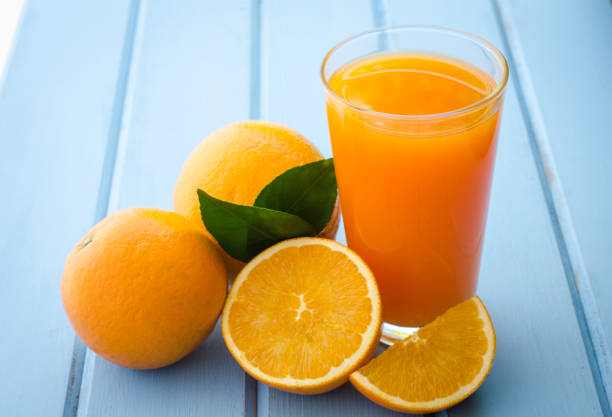 istock Fresh oranges and juice on the blue wood 682081210