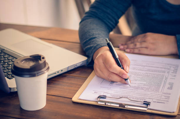 istock Businessman holding paperwork on the table and analyzing investment chart working in office. Business work concept. 682092046