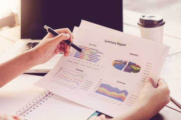 istock Businessman holding paperwork on the table and analyzing investment chart working in office. Business work concept 682092854