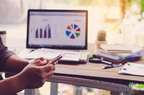 istock Working on a desk numerical analysis, financial accounting. Graphing on smartphone 682095336