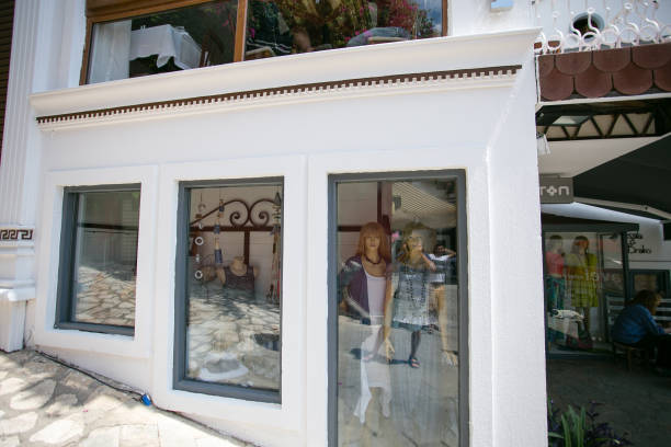 KALKAN, TURKEY - MAY 22 Clothing shop in Kalkan resort town of Turkey located in stone house painted white with mannequins dressed in blue colored clothes 2016