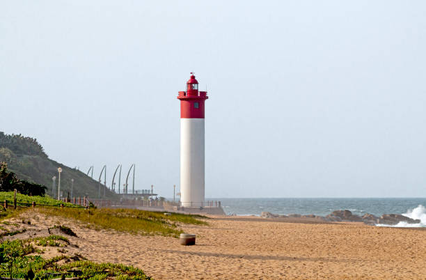 istock Green Vegetation Beach and RedLlighthouse Seascape 682100318