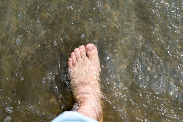 istock Man's foot in the water 682102832