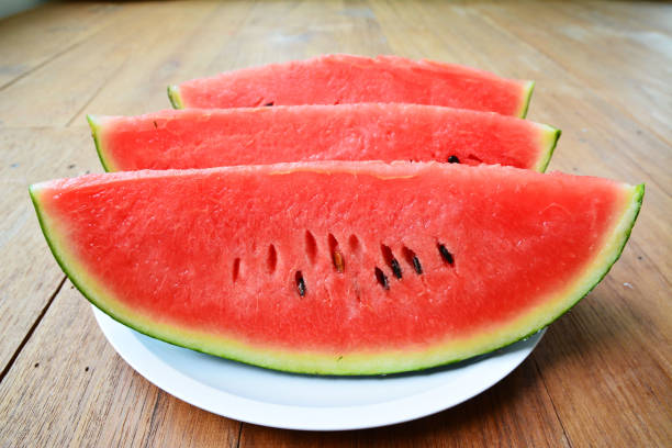 istock Fresh sliced watermelon wooden background 682107390
