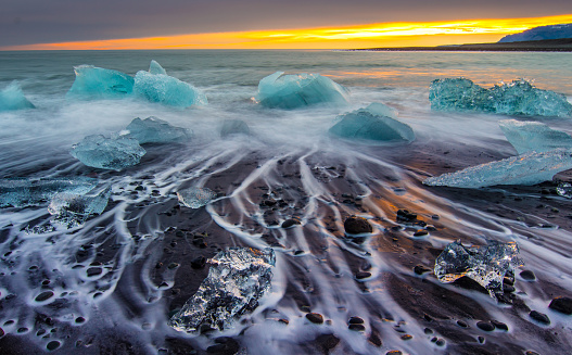 Icebergs Floating on Icy Beach at Sunrise, South Iceland