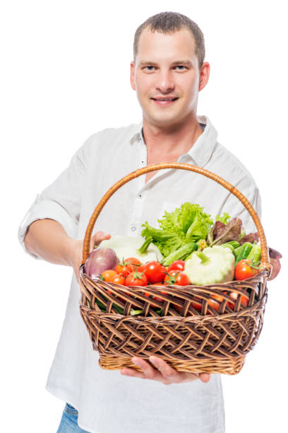 istock Farmer with a basket full of vegetables on a white background 682108050