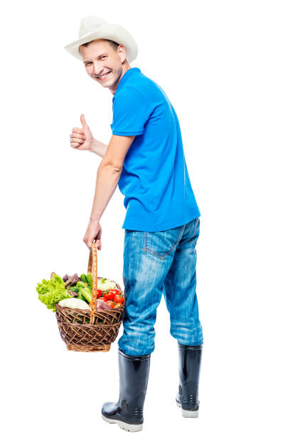 istock Backward farmer with a basket of vegetables on a white background 682108100