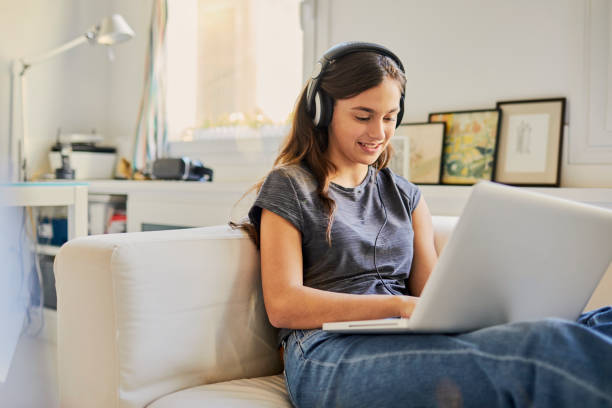 young teenager woman enjoying technology in a barcelona apartment. - spanish culture audio imagens e fotografias de stock