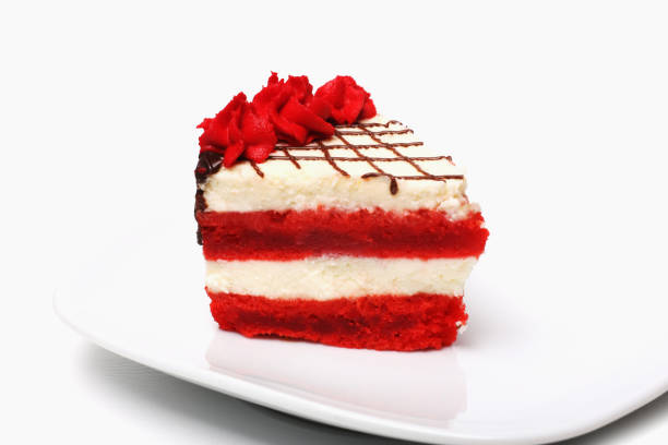 A piece of cherry cake on a plate on a white background