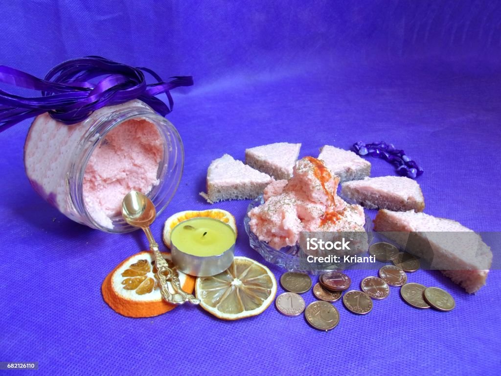 Caviar Cream Spread Red Caviar Luxury Cream, in a jar and spread on triangular slices of bread,decorated with a golden spoon, tea candle placed on dried rings of orange and lemon fruits,coins all in tranquil purple background Appetizer Stock Photo
