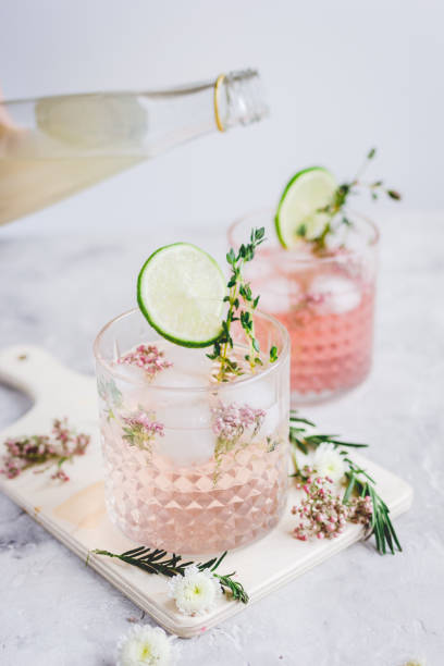 istock natural nonalcoholic cocktail with herbs and cut lime on stone desk background 682129656