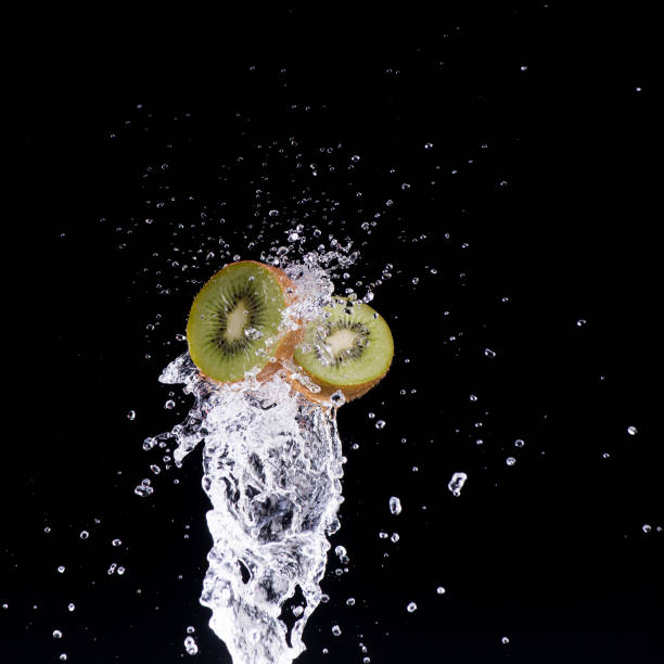 kiwi in water splash on black background
