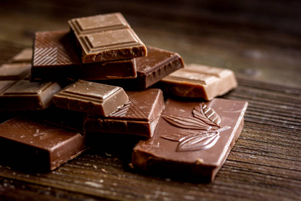 istock black and milk chocolate bars dark wooden table background 682132562