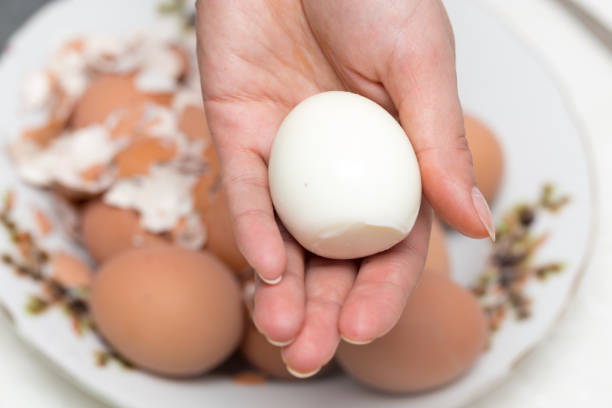 istock The girl is cleaning the egg with her hands 682144162