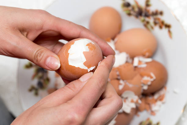 istock The girl is cleaning the egg with her hands 682144286