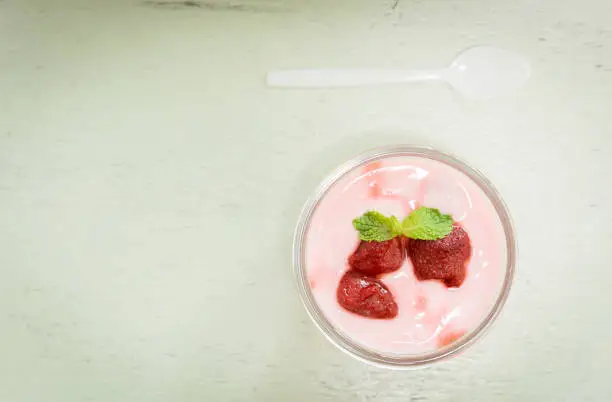 strawberry yogurt with strawberry  on wooden. strawberry yoghurt. pink yogurt. strawberry in strawberry yogurt. heart in yogurt. heart. valentine 's day.