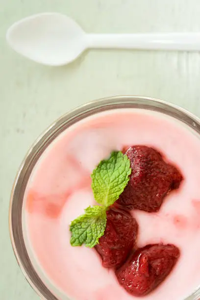 strawberry yogurt with strawberry  on wooden. strawberry yoghurt. pink yogurt. strawberry in strawberry yogurt. heart in yogurt. heart. valentine 's day.