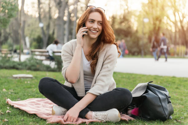 istock Smiling young woman talking on the phone 682147732