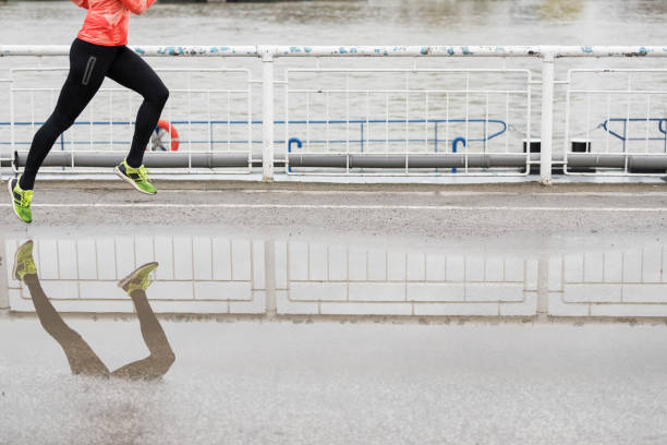 istock Woman jogging after rain 682147824