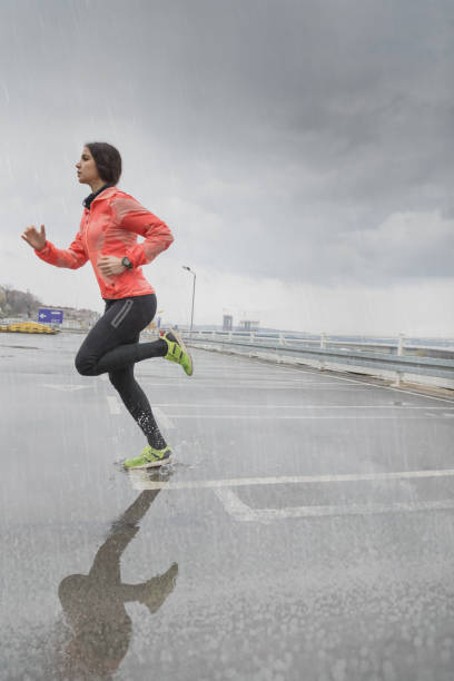 istock Woman jogging on bad weather 682148142