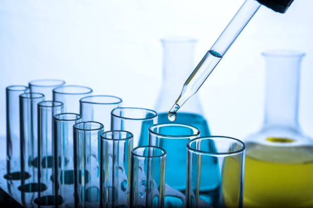 istock Dropping chemical liquid to test tubes 682148704