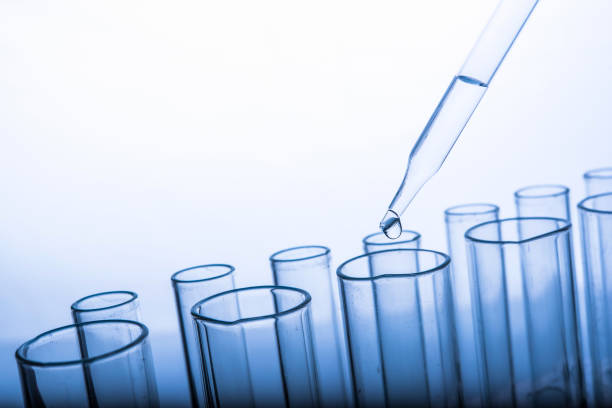 istock Dropping chemical liquid to test tubes 682148706