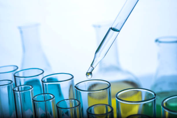 istock Dropping chemical liquid to test tubes 682148714