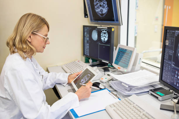 istock Mature female doctor analyzing X-ray reports 682151800