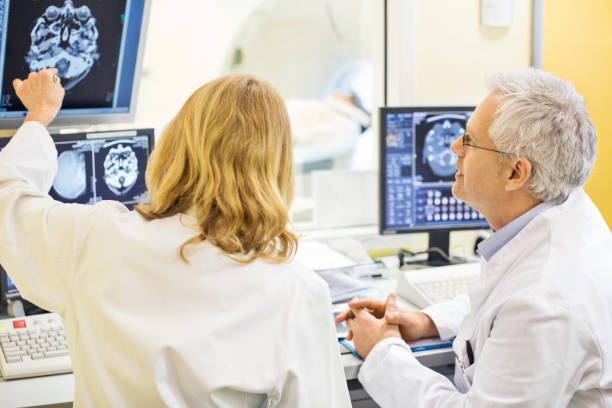istock Mature doctors analyzing X-ray image at hospital 682152036