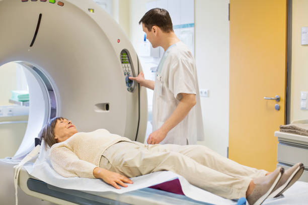 istock Radiologist operating scanner with female patient 682154526