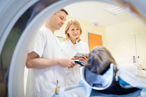 istock Doctors and senior patient during MRI scan 682158124