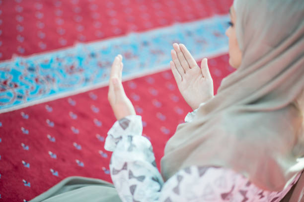 istock muslim woman praying in mosque 682158424