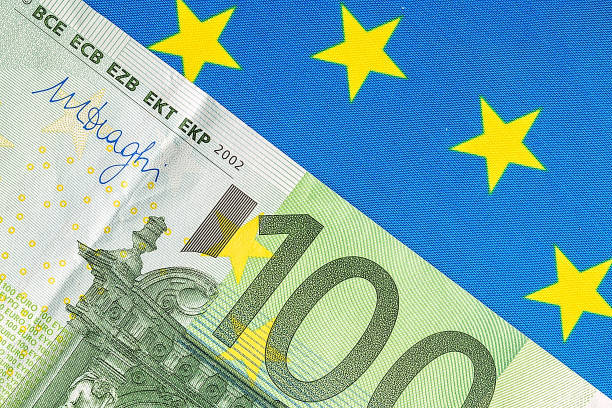 istock EU flag and many euro banknotes 682159196