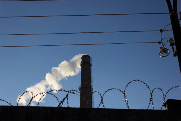 pipe smoke and a barbed wire pipe smoke and a barbed wire. security plant barbed wire wire factory sky stock pictures, royalty-free photos & images