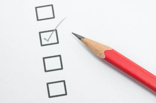 checklist box and red pencil on white paper.