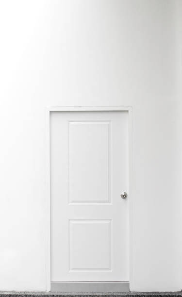 istock White door on white wall. Scandinavian style 682162462