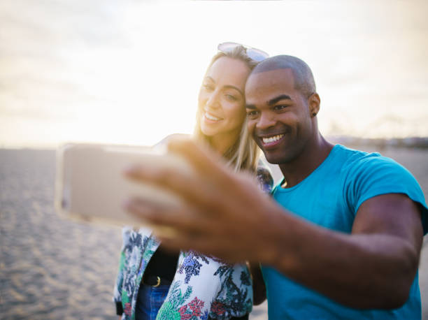 istock couple taking a break from riding bikes to take selfies 682168782