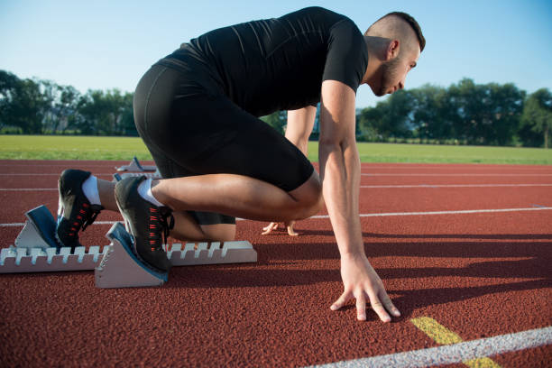 istock Runners preparing for race at starting blocks 682172636