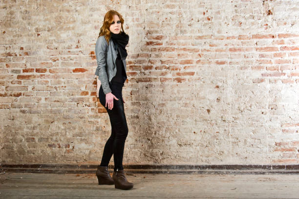 istock pretty young woman in leather jacket and pant 682179272