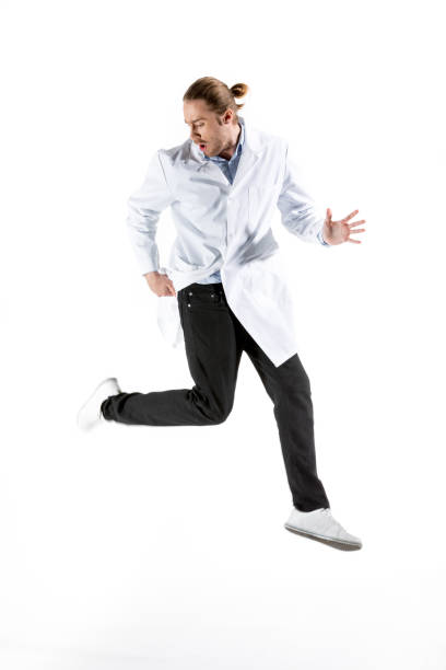 istock young doctor in white coat jumping isolated on white 682179450