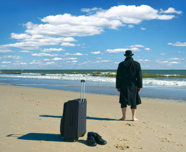 istock Arrival of black dressed tourist at the beach 682183134