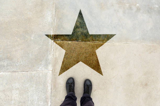 Talented young man on the road with star shape imprint - talent, skill, gifted person, vip, prize and award concept