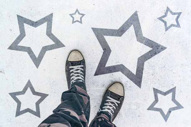 istock Sneakers on the road with star shape imprint 682183274