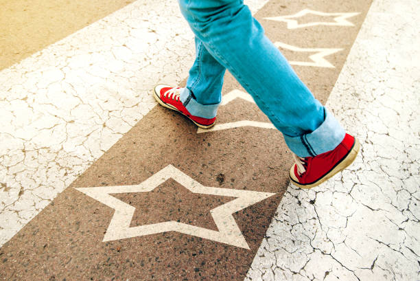 istock Sneakers on the road with star shape imprint 682183314